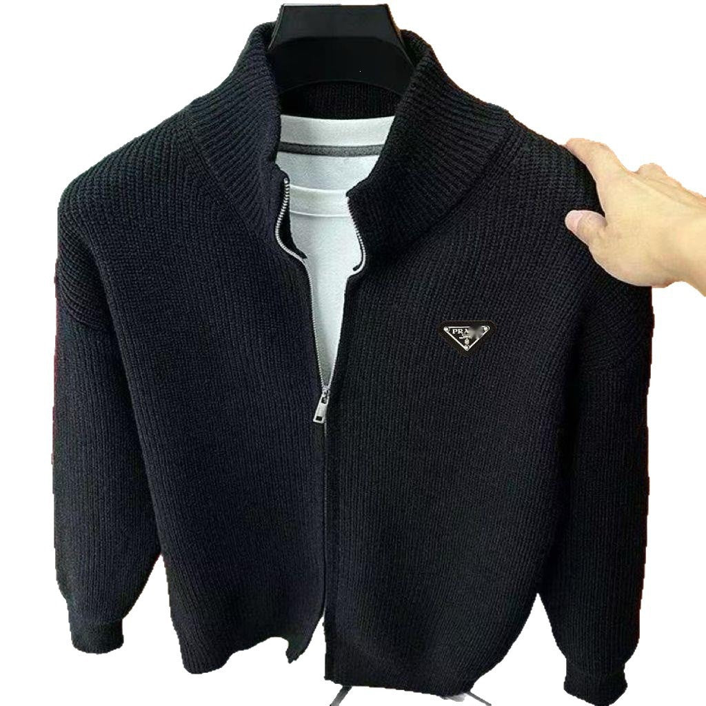 Black zip-up sweater on a hanger with a white background