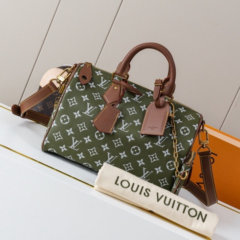 Louis Vuitton monogram Speedy handbag in olive green canvas with brown leather handles and trim, displayed on a white surface with a Louis Vuitton dust bag in front.