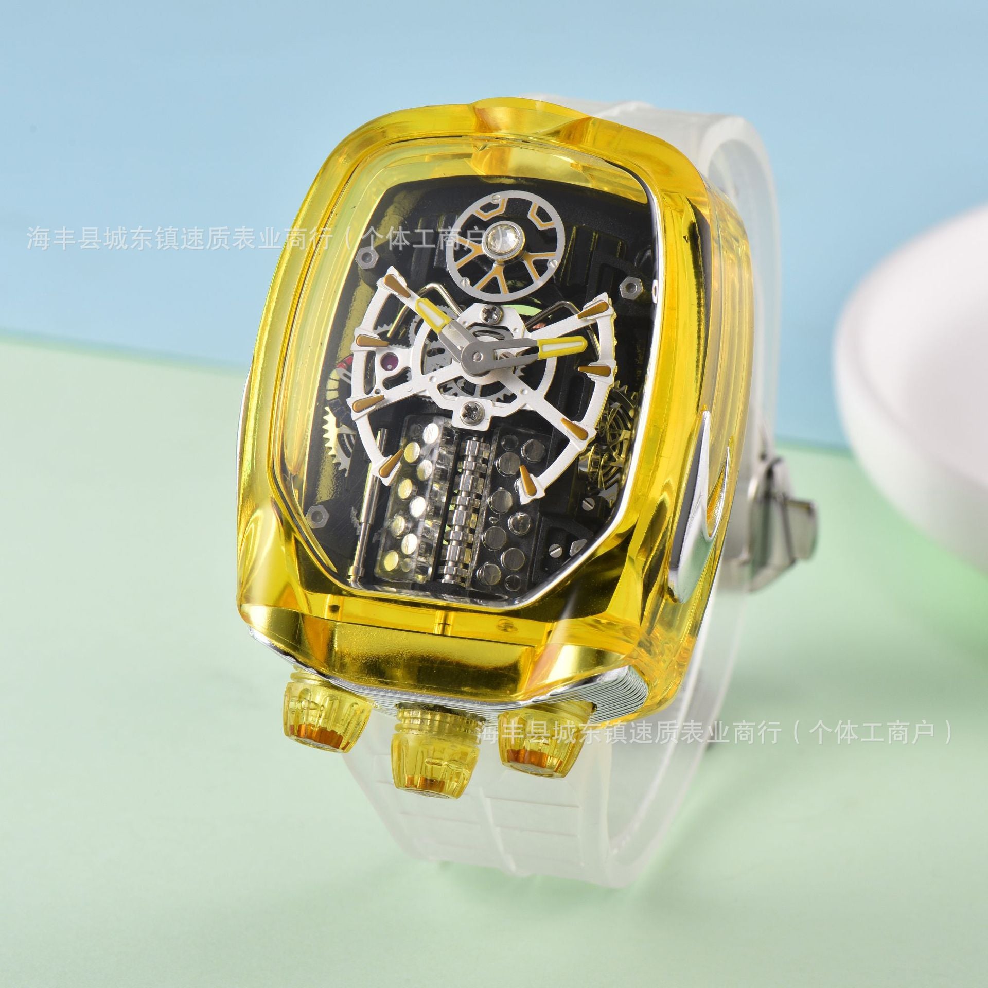 Transparent yellow wristwatch with mechanical components on a light blue and green gradient background