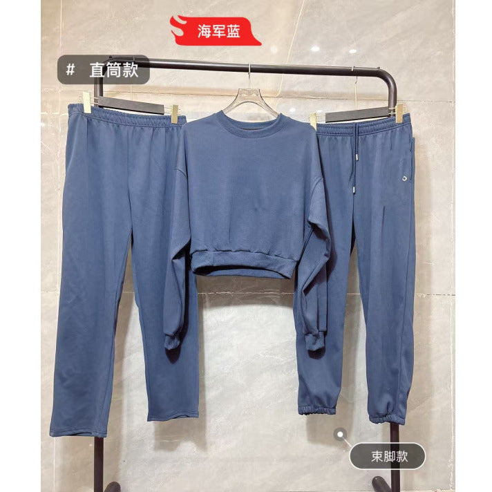 Blue pajama set hanging on a rack against a tiled wall.