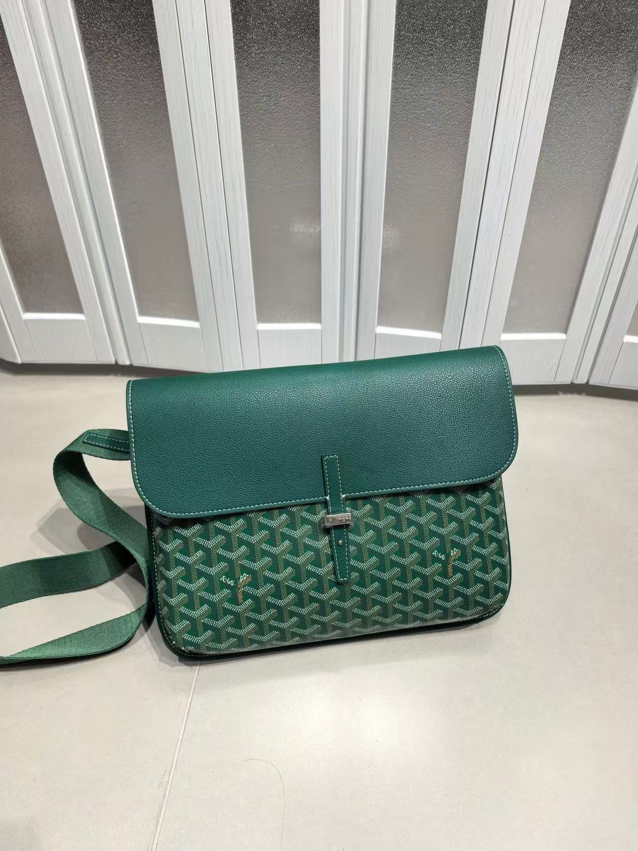 Green patterned handbag on a light surface with a white background