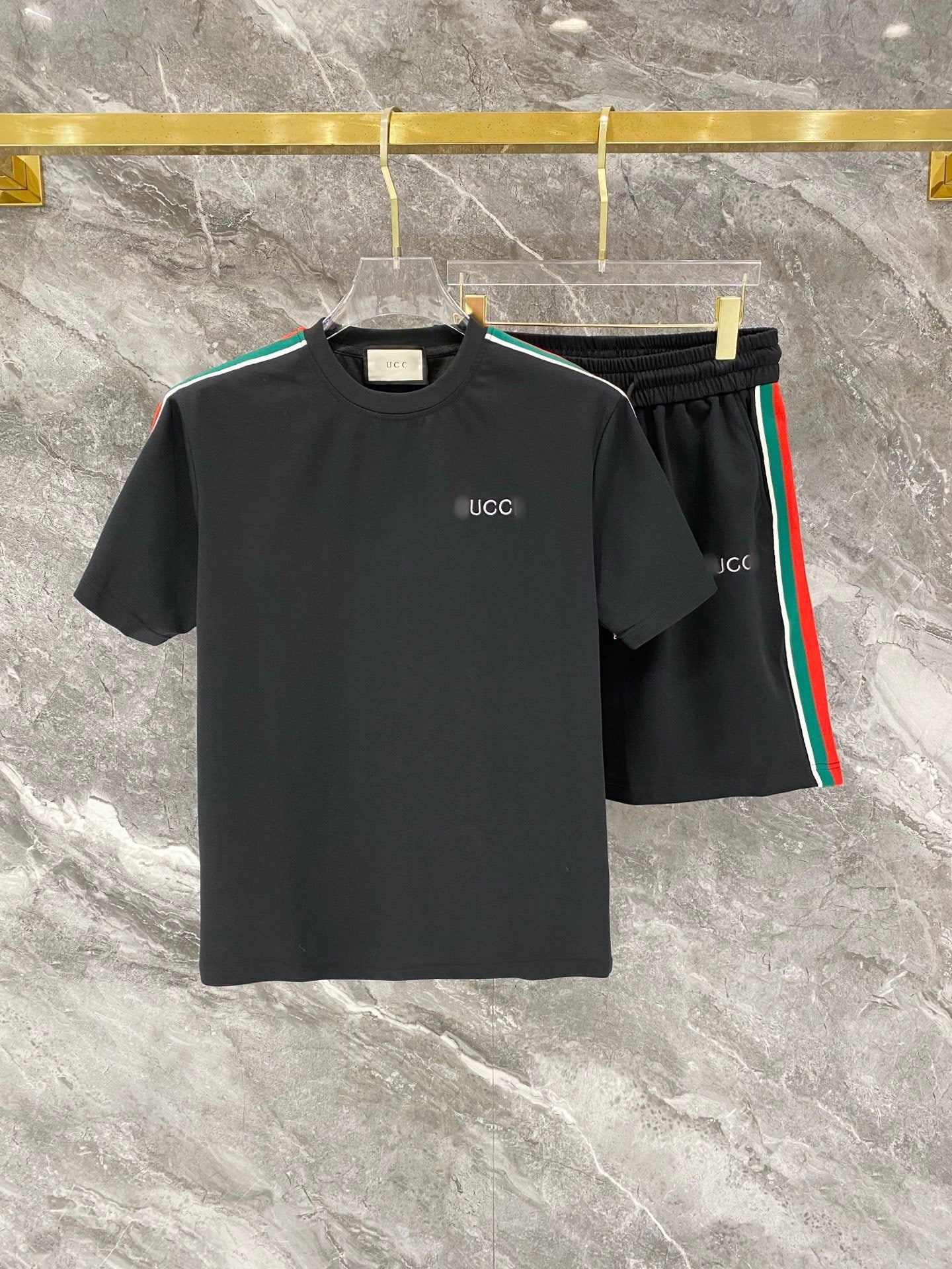 Black Gucci t-shirt and shorts set on a marble surface