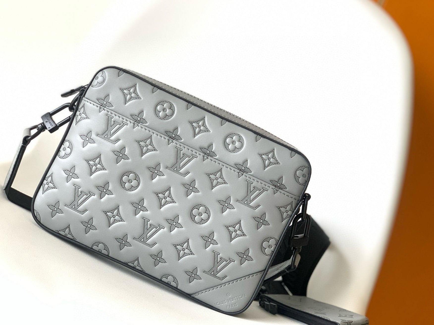 Silver monogrammed handbag on a white background