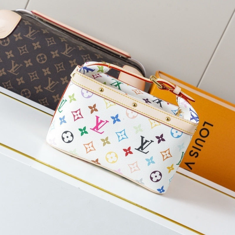 A Louis Vuitton monogram canvas pouch in white with multicolor monogram motifs, displayed on a white surface next to an orange Louis Vuitton box.