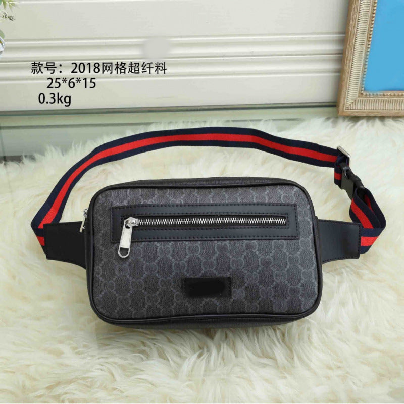 Black waist bag with red and blue strap on a white surface