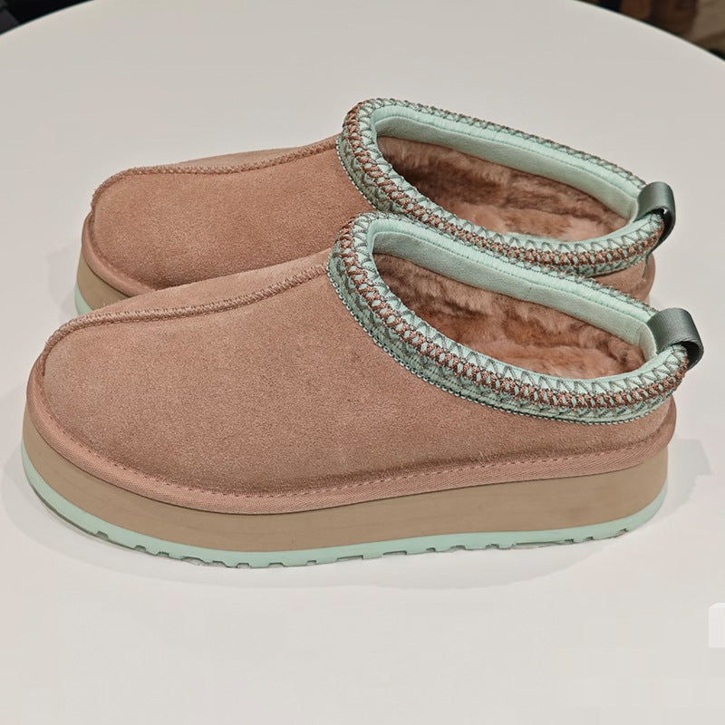A pair of slip-on platform slippers in dusty pink suede with mint green trim and a plush lining, displayed on a white surface.