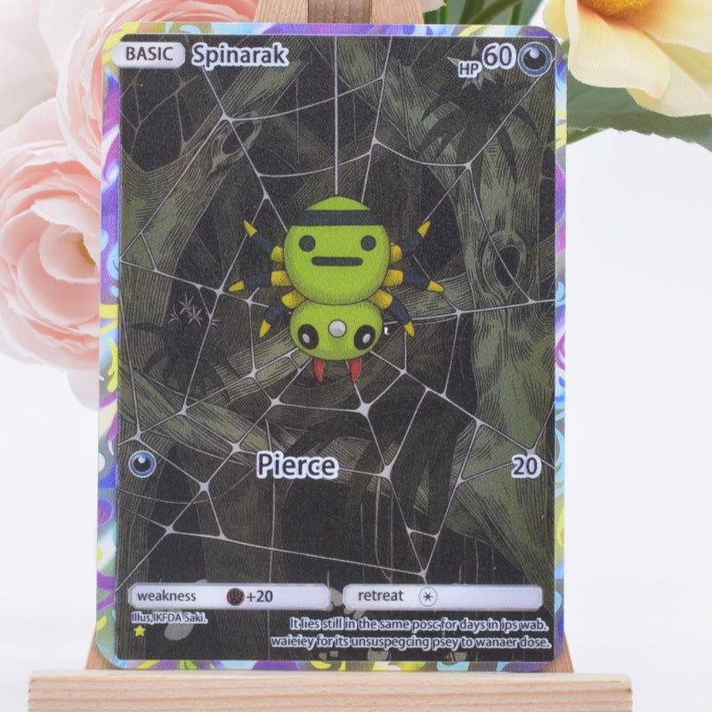 A holographic Pokémon trading card of Spinarak from the Silver Tempest expansion, displayed on a small wooden stand with soft pink and yellow flowers in the background.