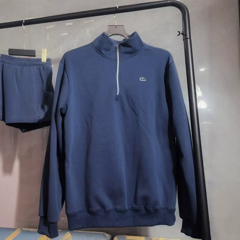 Blue sweatshirt with a logo on a hanger against a neutral background