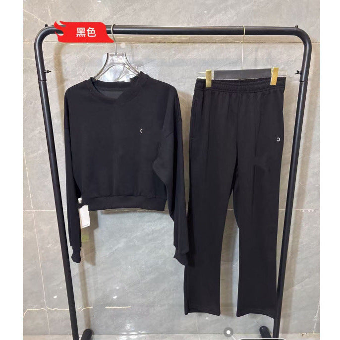 Black outfit on a clothing rack against a tiled wall