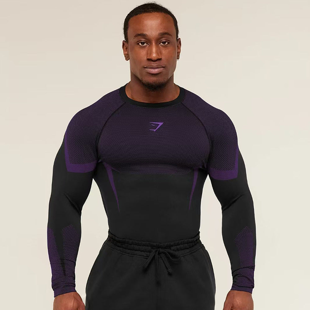 Man wearing a black and purple athletic outfit with a logo on a beige background