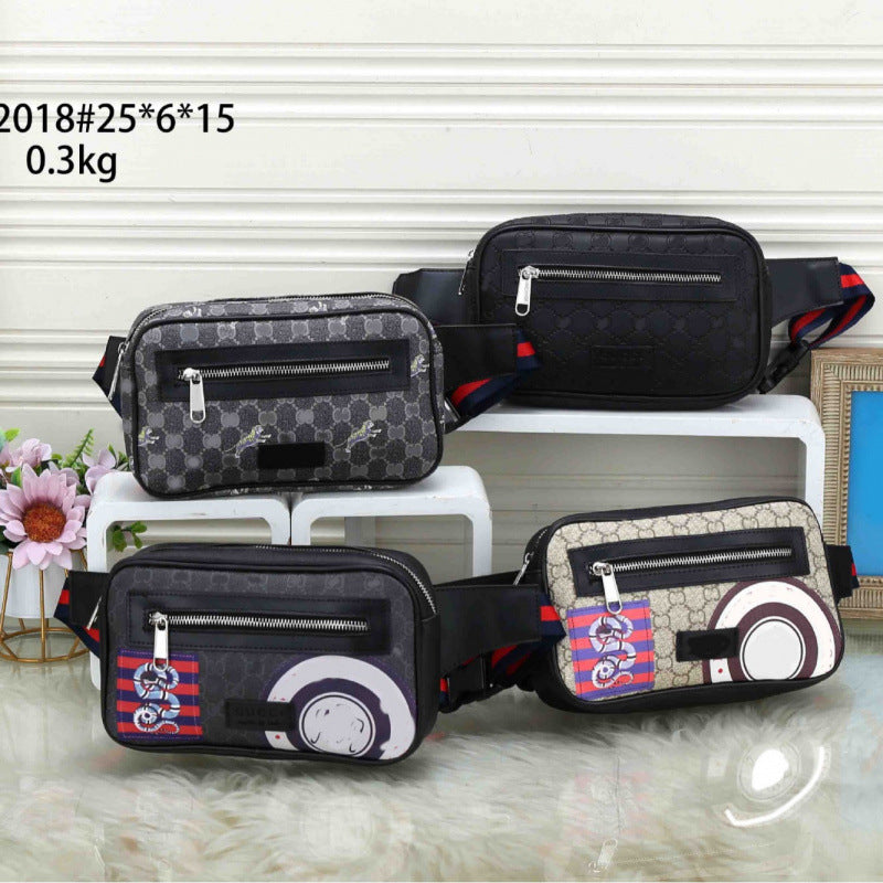 Four patterned crossbody/waist bags arranged on white display blocks and a white faux-fur surface. The bags have black straps and trim, with different printed designs: one black monogram, one gray monogram, one beige monogram with red/blue accents, and one dark gray with a large white circular graphic and red/blue striped detail.