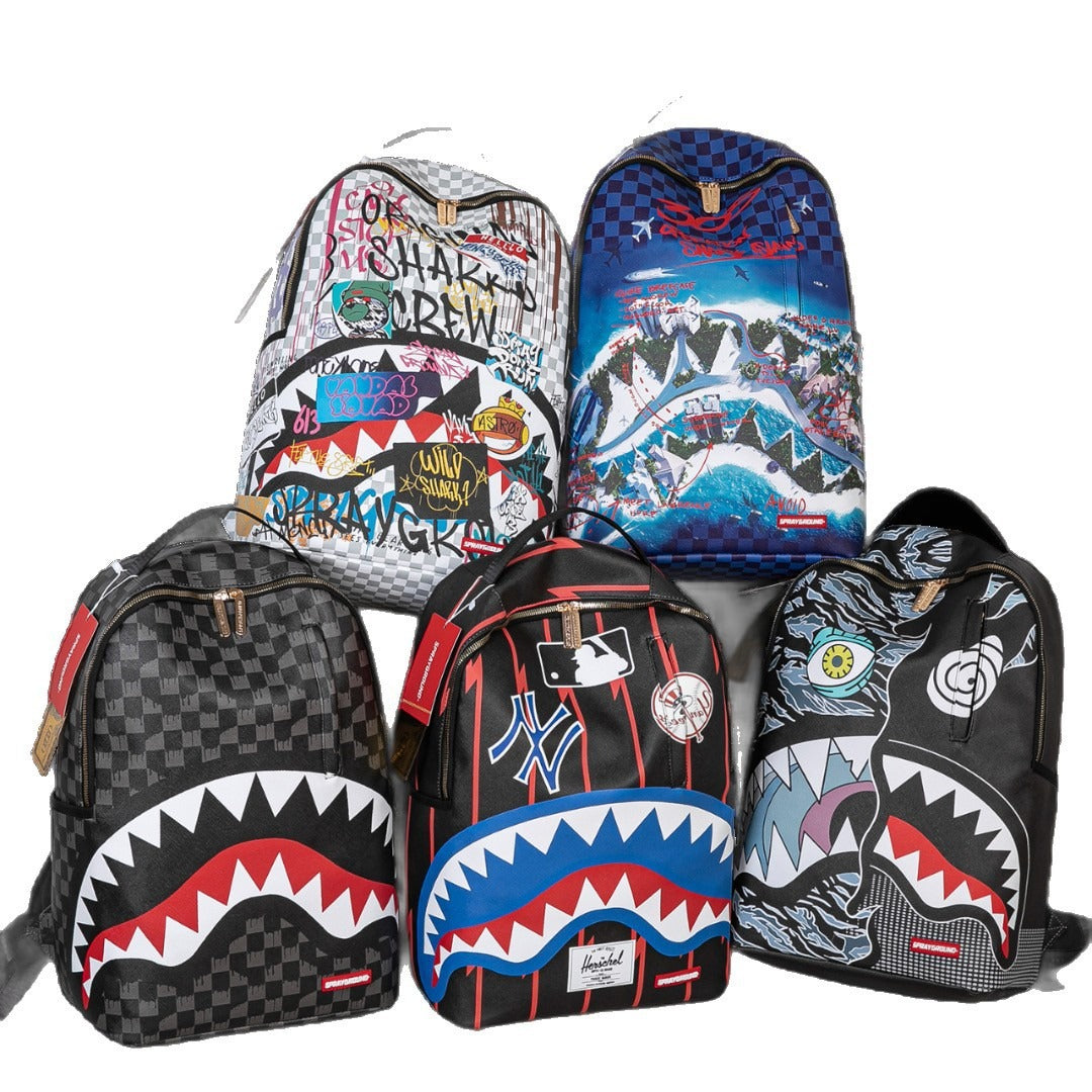 Five Spray Park backpacks in various graphic designs, including shark mouth patterns, checkerboard prints, and sports team logos, arranged against a white background.