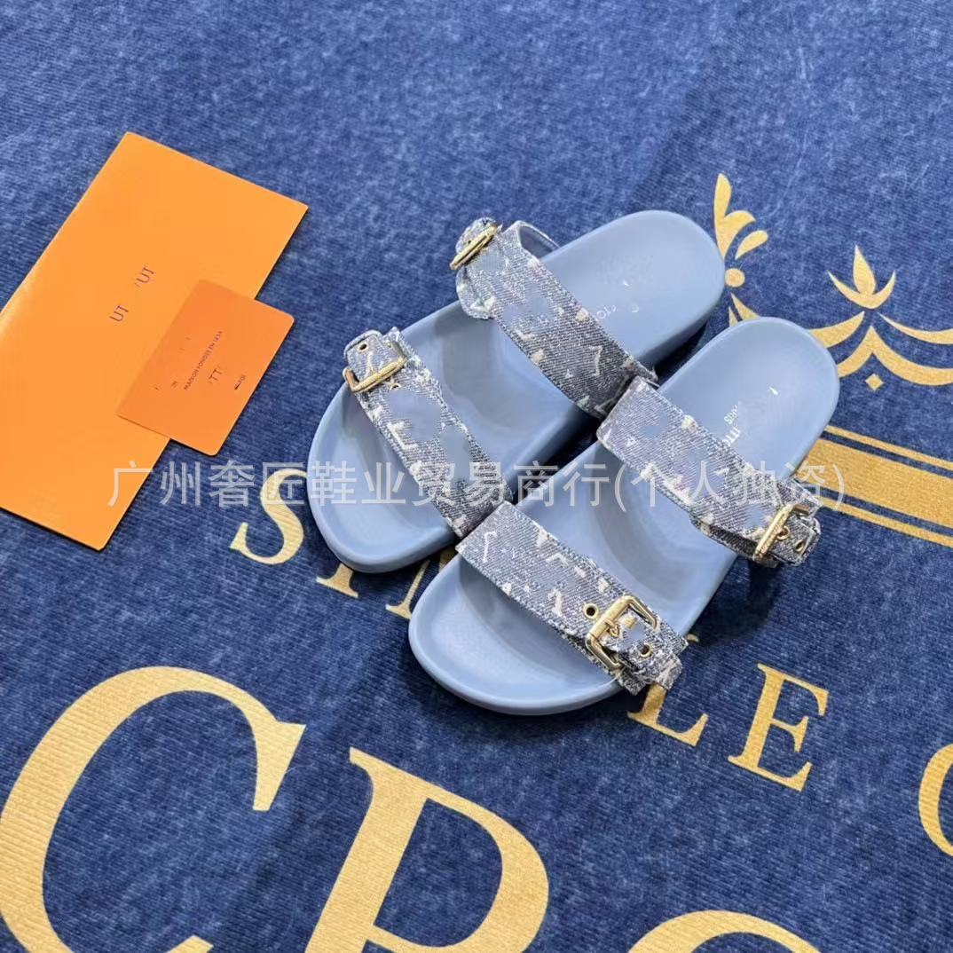 Blue sandals with decorative straps on a blue background with gold text