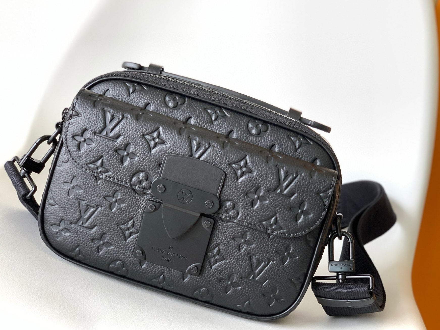 Black leather bag with brand logo on a white background