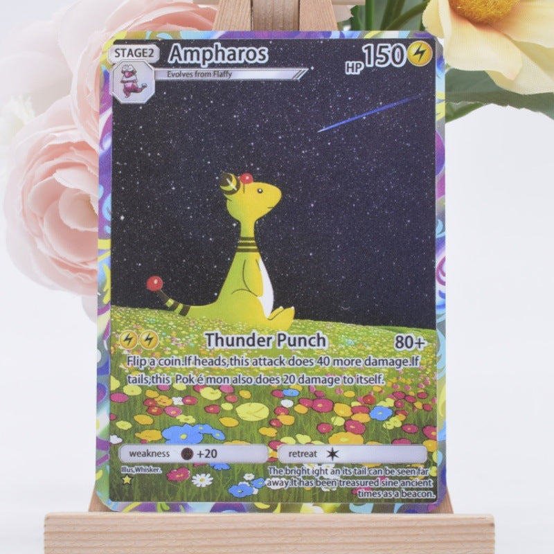 A Pokémon trading card featuring Ampharos, displayed upright on a small wooden stand with soft pink and yellow flowers blurred in the background.