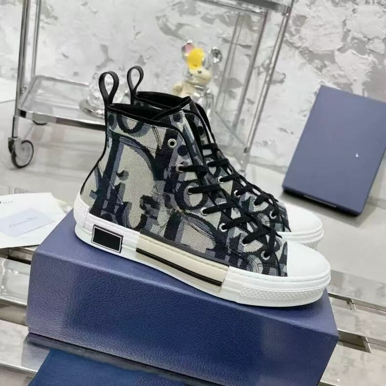 Black and white high-top sneakers on a blue box with a blurred background