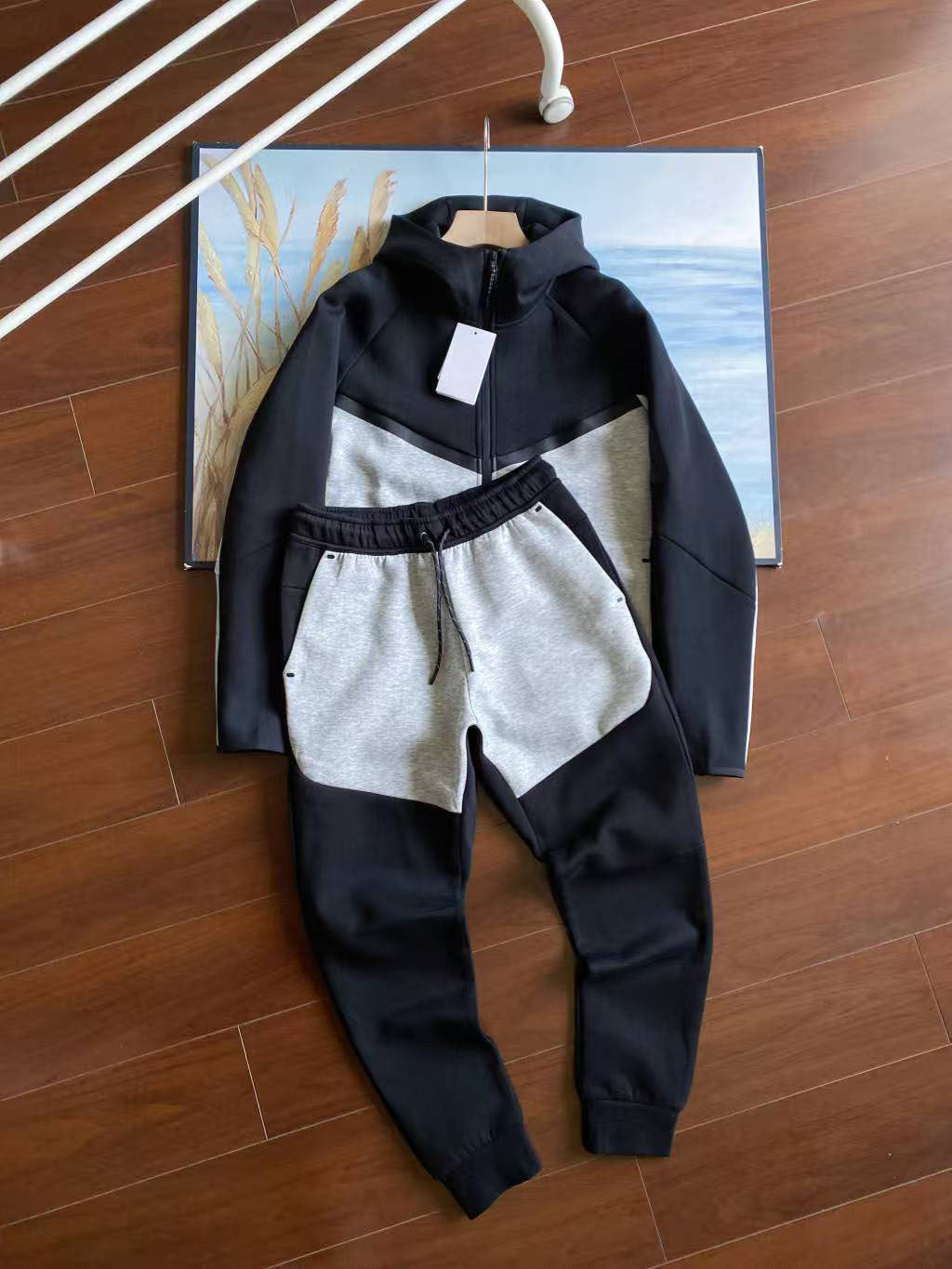 Children's black and white outfit on a wooden floor with a map in the background