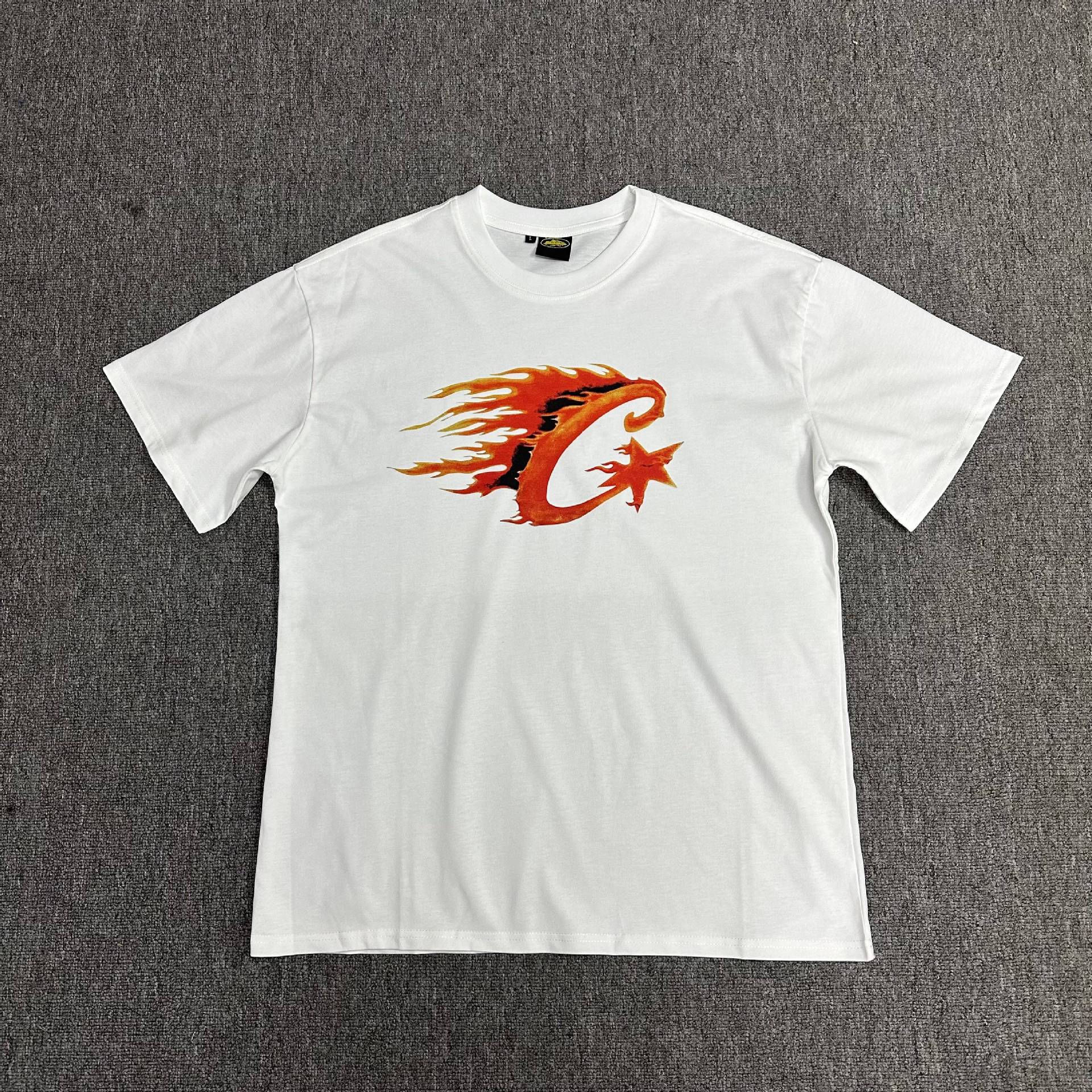 White t-shirt with a red and orange graphic design on a gray background