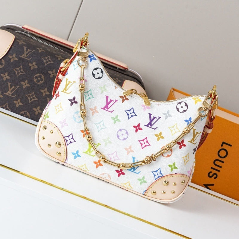 A white Louis Vuitton shoulder bag with a colorful monogram pattern, gold chain strap, and beige leather trim, displayed next to an orange Louis Vuitton box and another monogram bag.