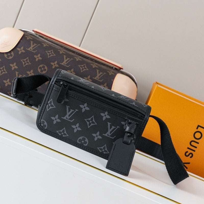 A Louis Vuitton monogram belt bag in black coated canvas with a gray monogram print, shown alongside a matching brown monogram pouch and an orange Louis Vuitton box on a white surface.