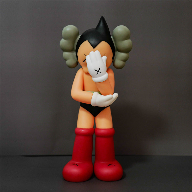 Cartoon character figurine with black hair and red boots on a dark background