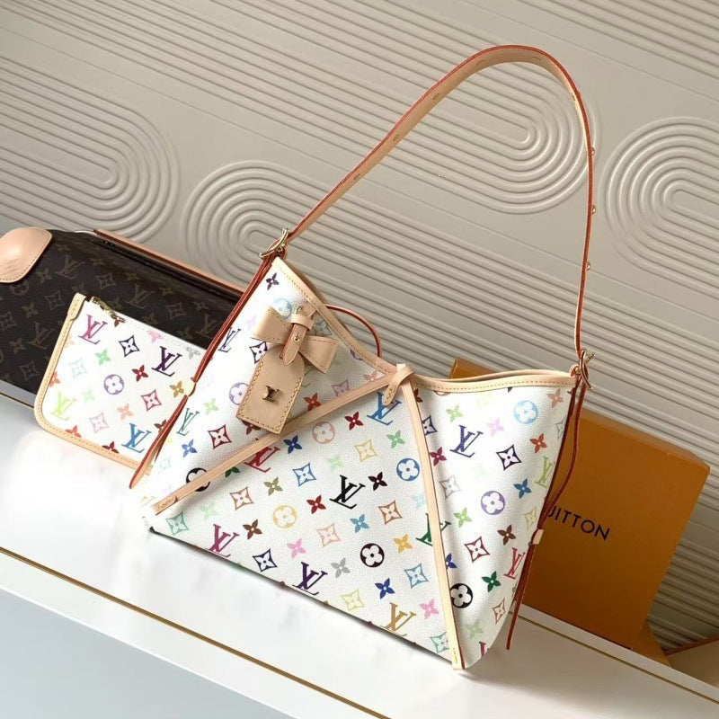 Louis Vuitton monogram canvas shoulder bag with a beige leather strap and bow detail, displayed on a white surface with a Louis Vuitton box in the background.