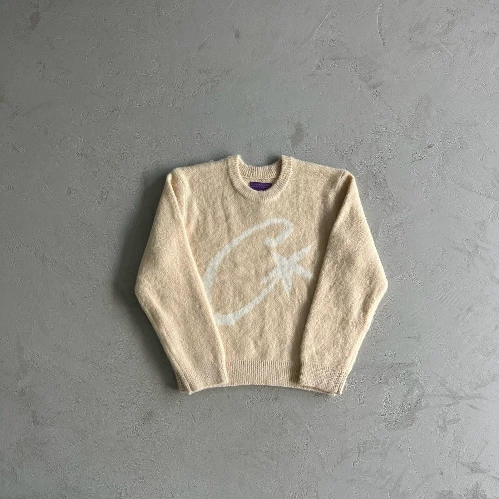 Beige sweater on a gray textured background