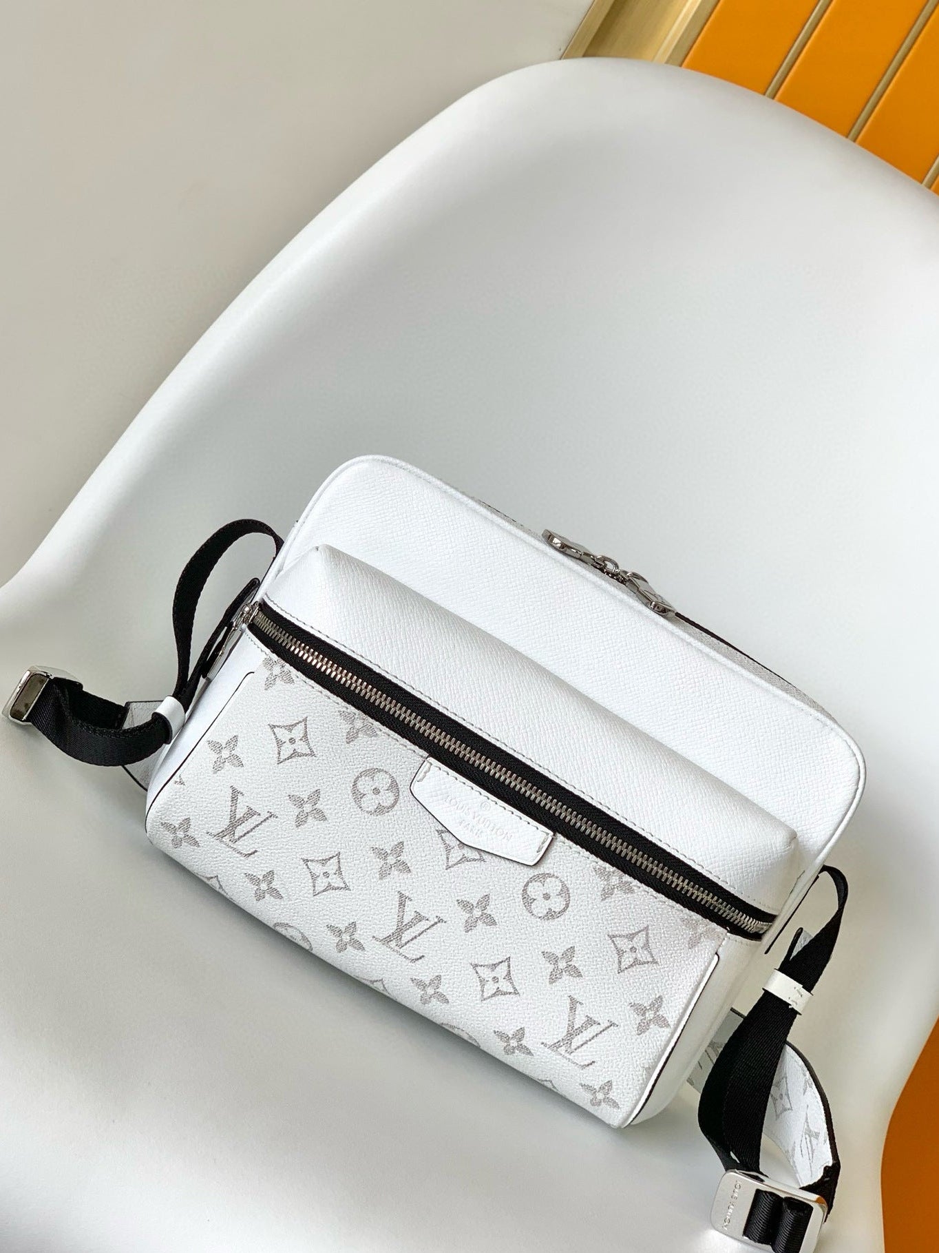 White handbag with black monogram pattern on a white surface