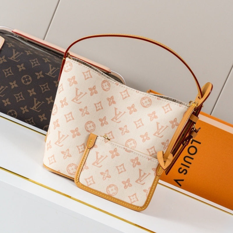 Louis Vuitton monogram canvas handbag with a top handle and front pouch, displayed next to a Louis Vuitton box on a white surface.