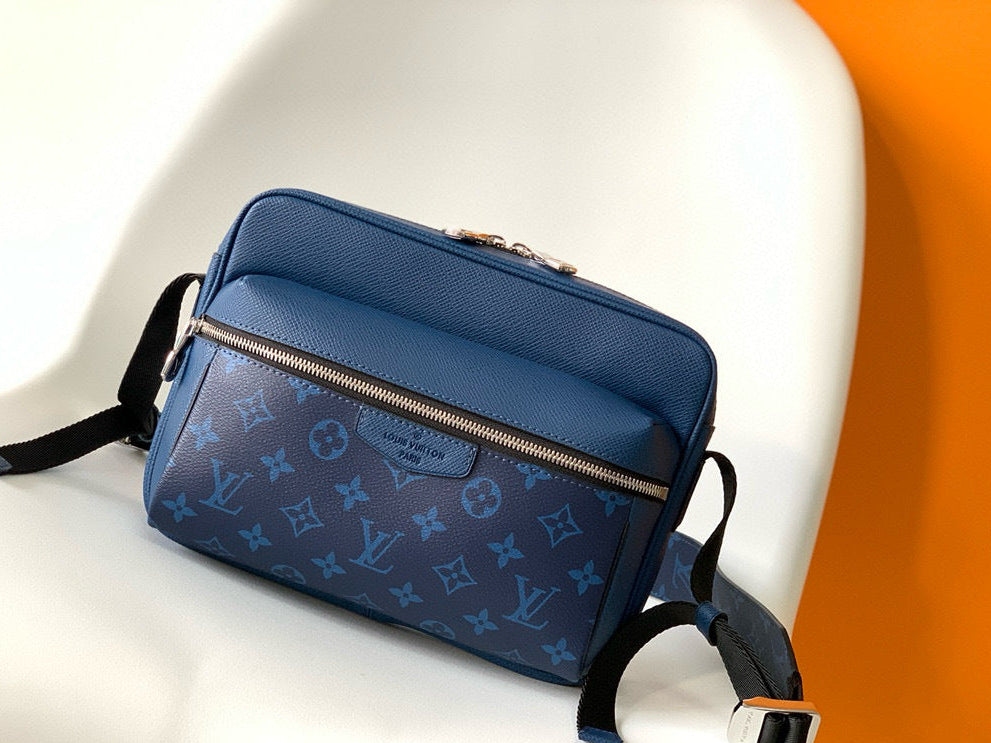 Blue patterned bag on a white chair with an orange background