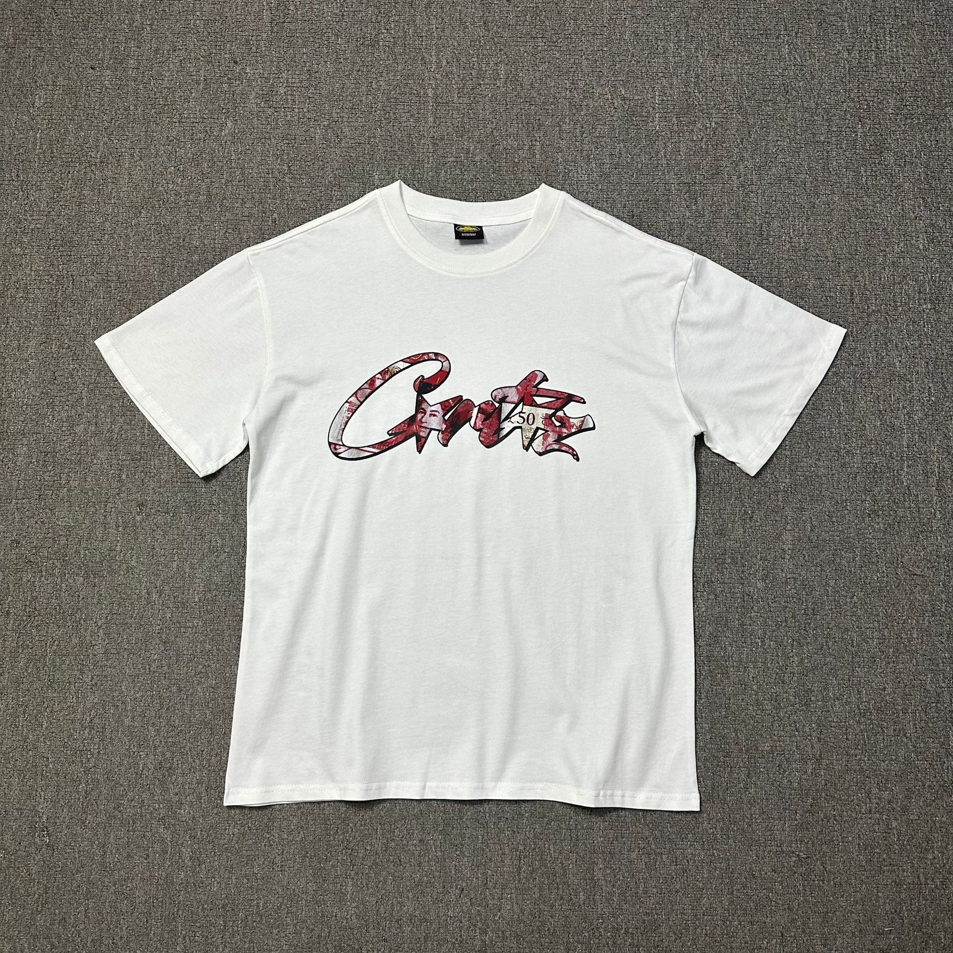 White t-shirt with red and black graphic design on a gray background