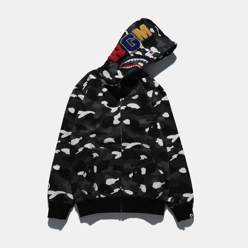 Black and white camouflage hoodie with colorful shark mouth design on a white background