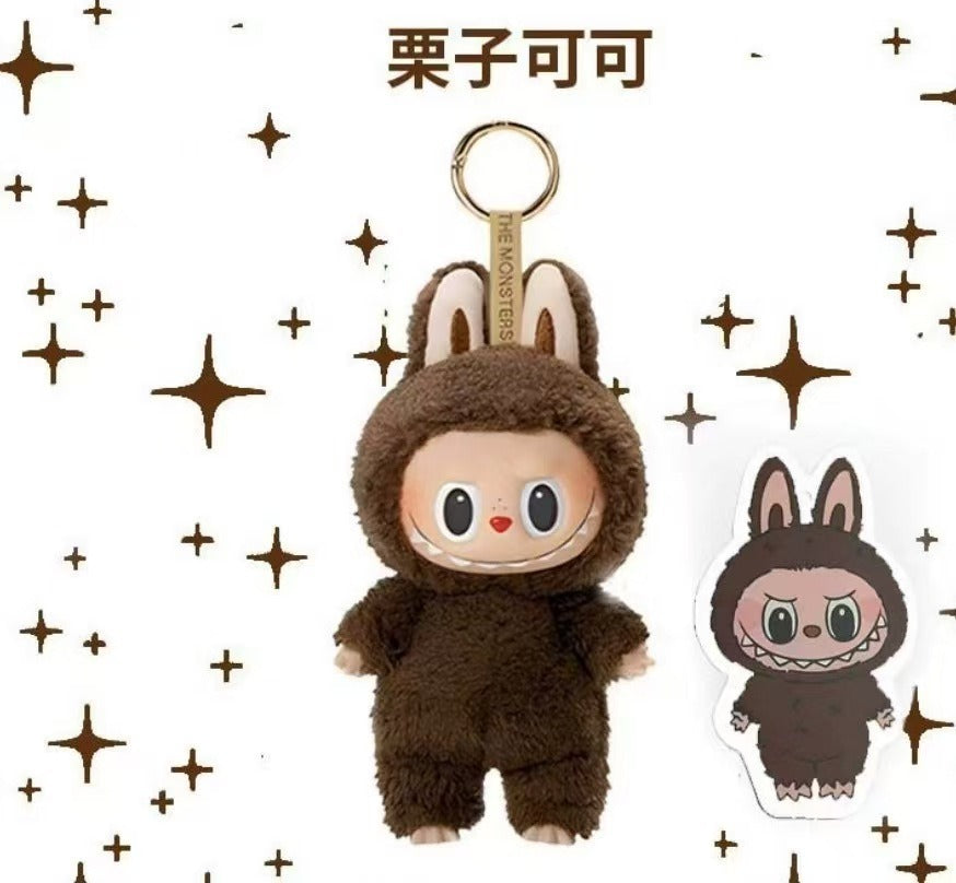 A plush character keychain in a brown furry outfit with bunny ears and a gold key ring, shown on a white background with brown star graphics. A smaller matching die-cut sticker is shown to the right, and the Chinese text '眠花多品' appears at the top.