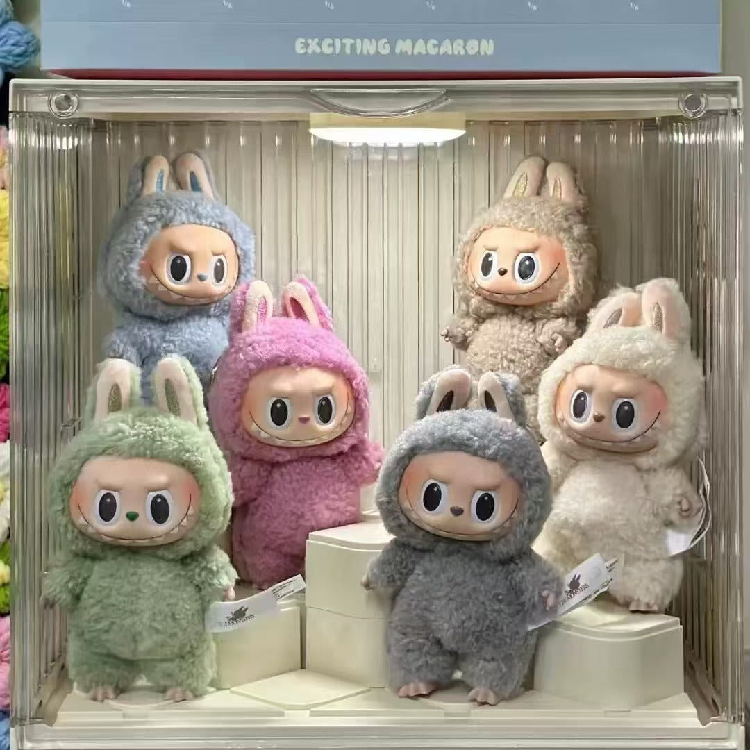 Set of plush toys in colorful costumes displayed in a clear case.