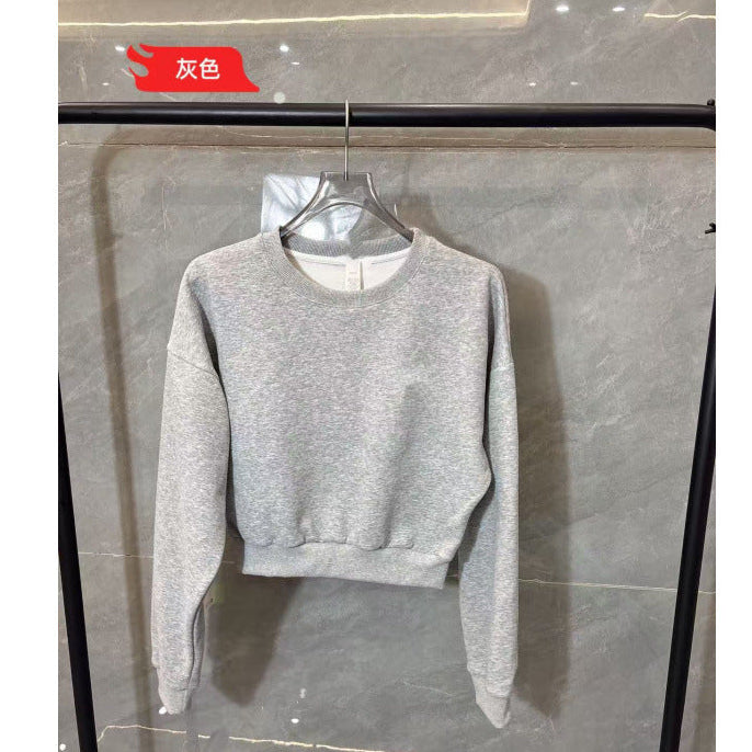 Gray sweatshirt on a hanger against a gray background