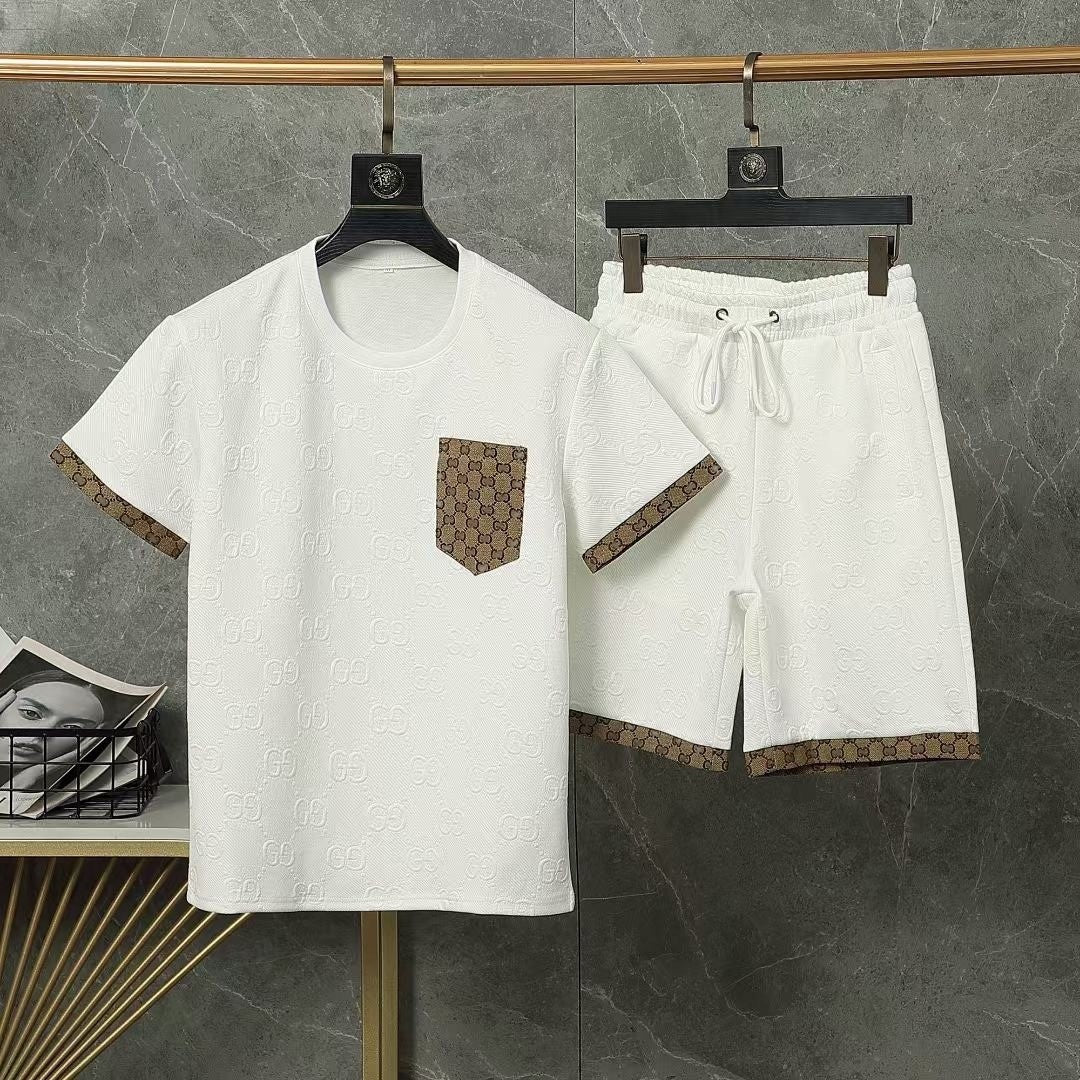 White t-shirt and shorts set with brown pocket design on hangers against a gray background