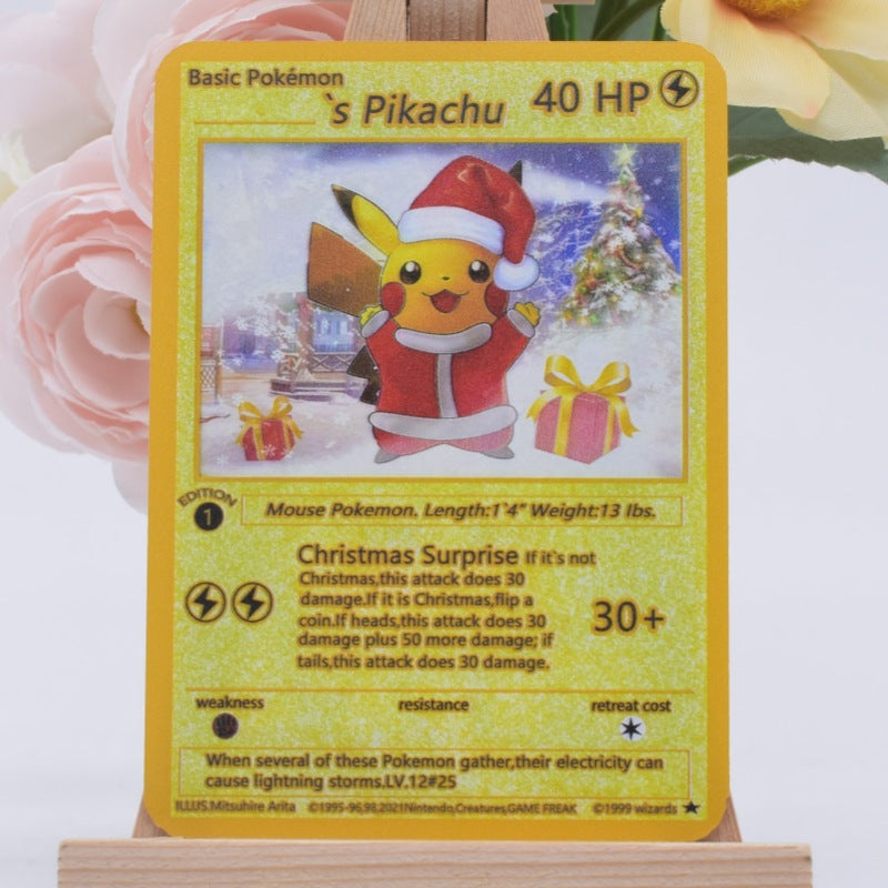 A holographic Pokémon trading card featuring Pikachu dressed in a Santa suit, displayed on a small wooden stand with blurred pink roses in the background.