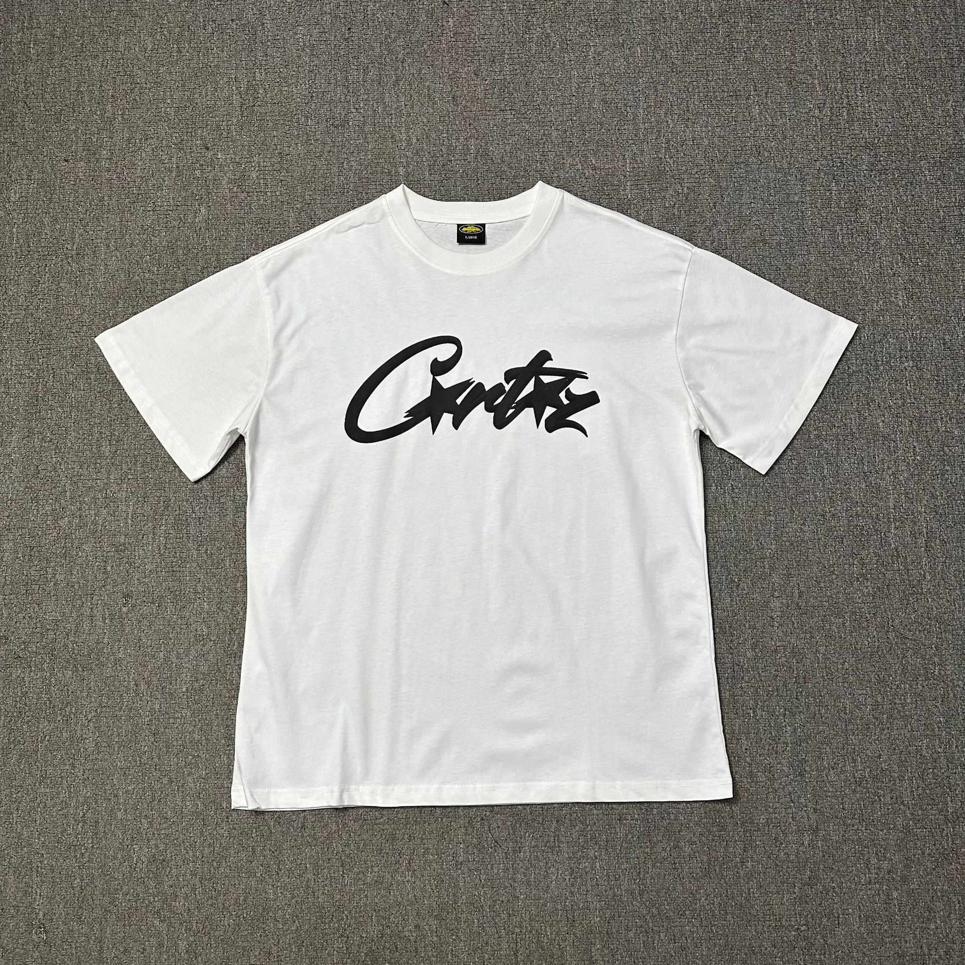 White t-shirt with black text on a gray background