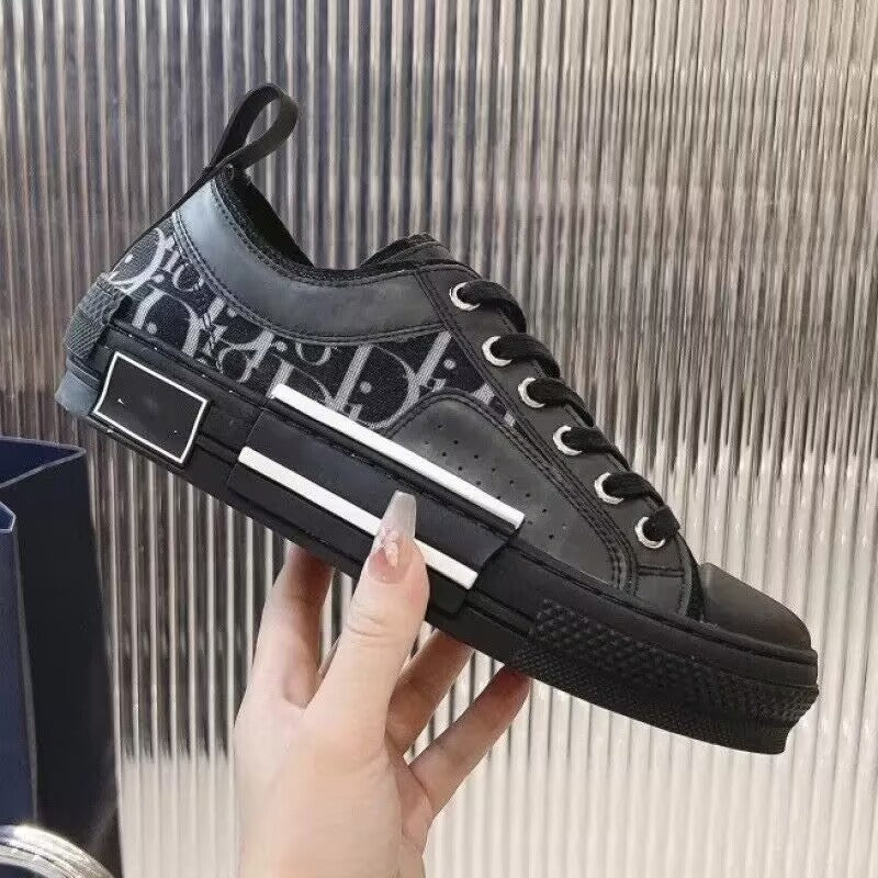 Black sneaker with brand logo held by a hand against a metallic background