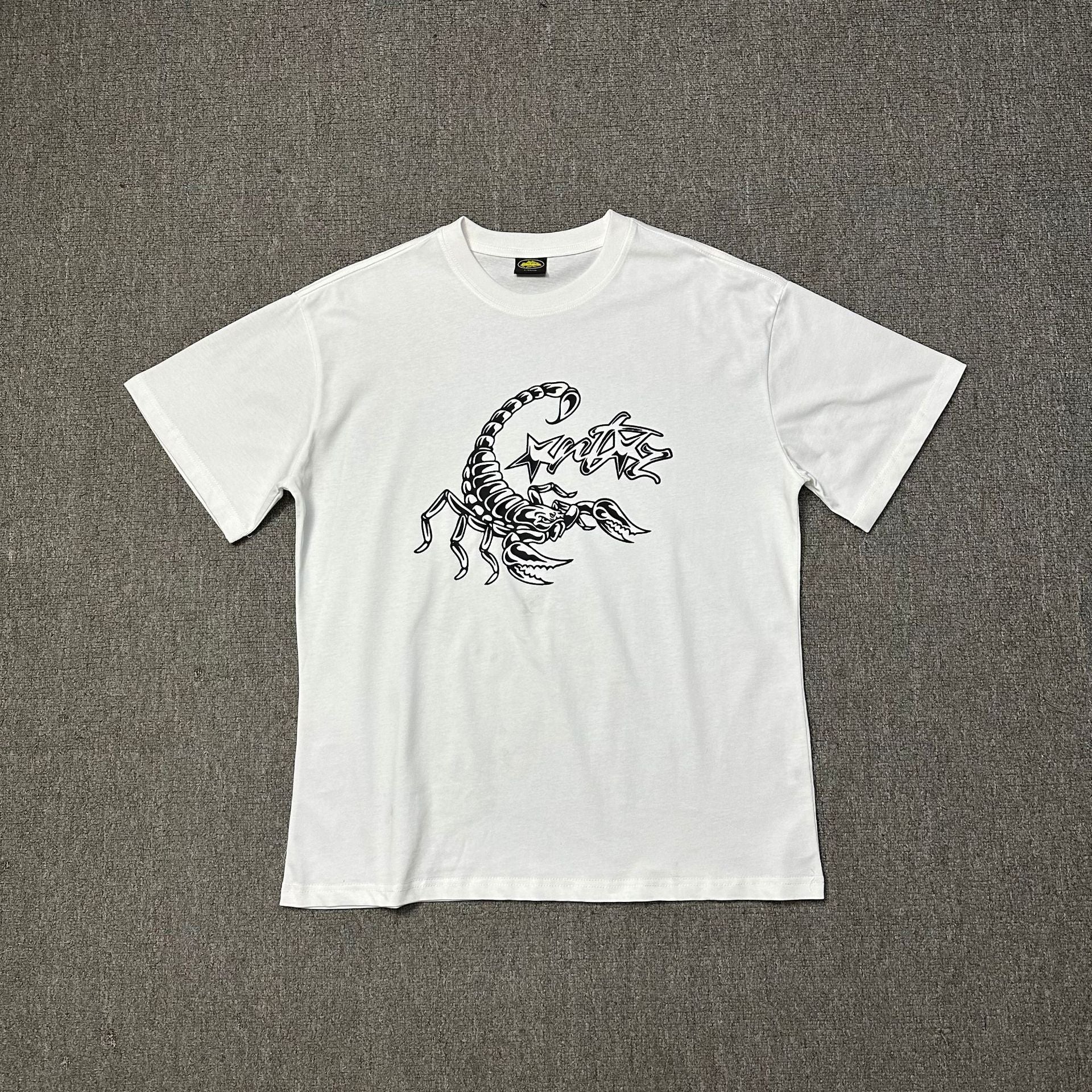 White t-shirt with black scorpion design on a gray background