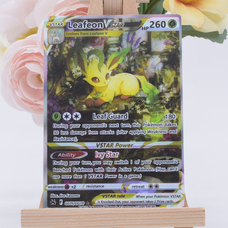 A VSTAR Leafon Star Pokémon trading card displayed upright on a small wooden stand, with soft pink flowers blurred in the background.