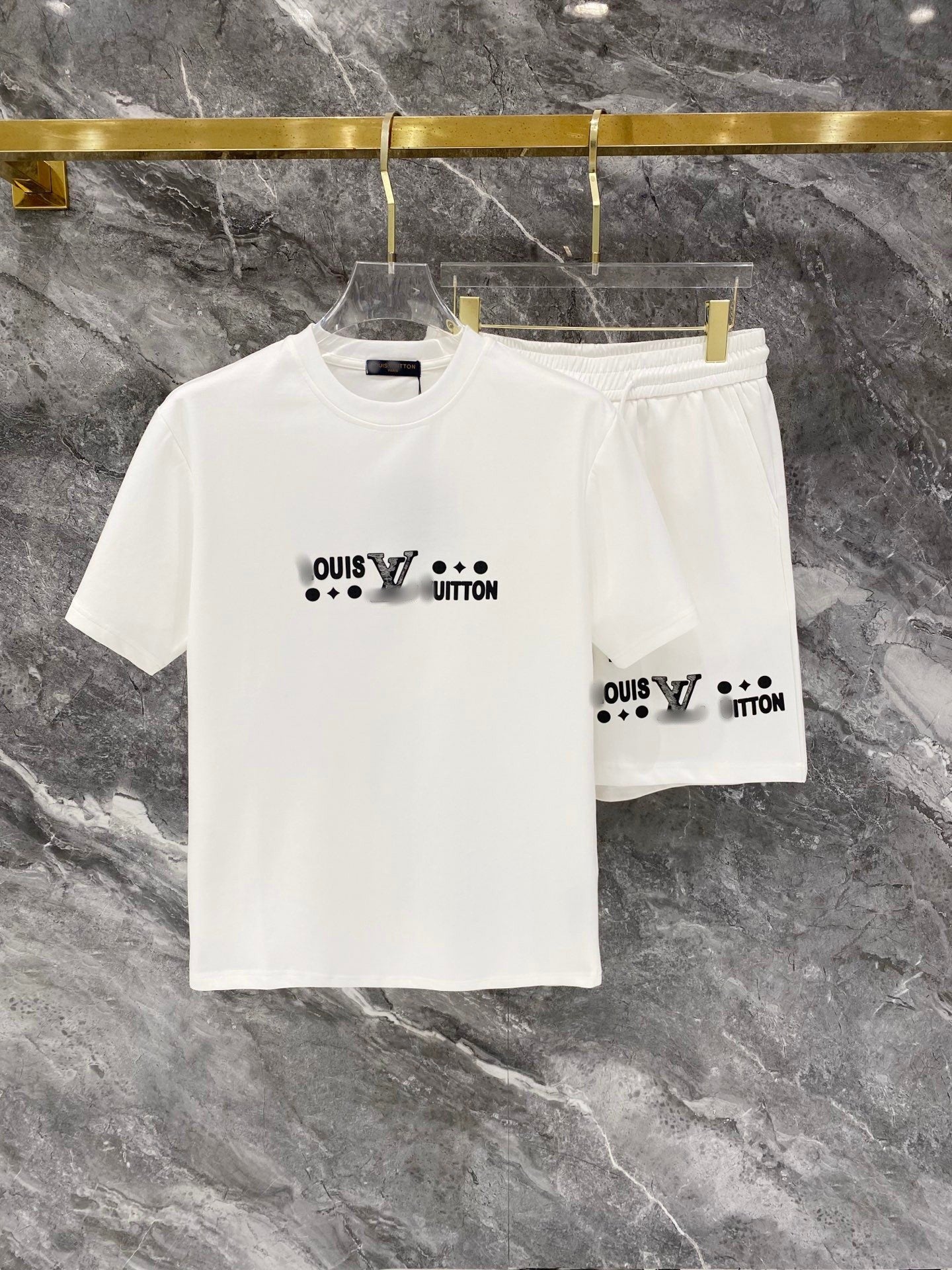 White t-shirt and shorts set with Louis Vuitton logo on a marble surface