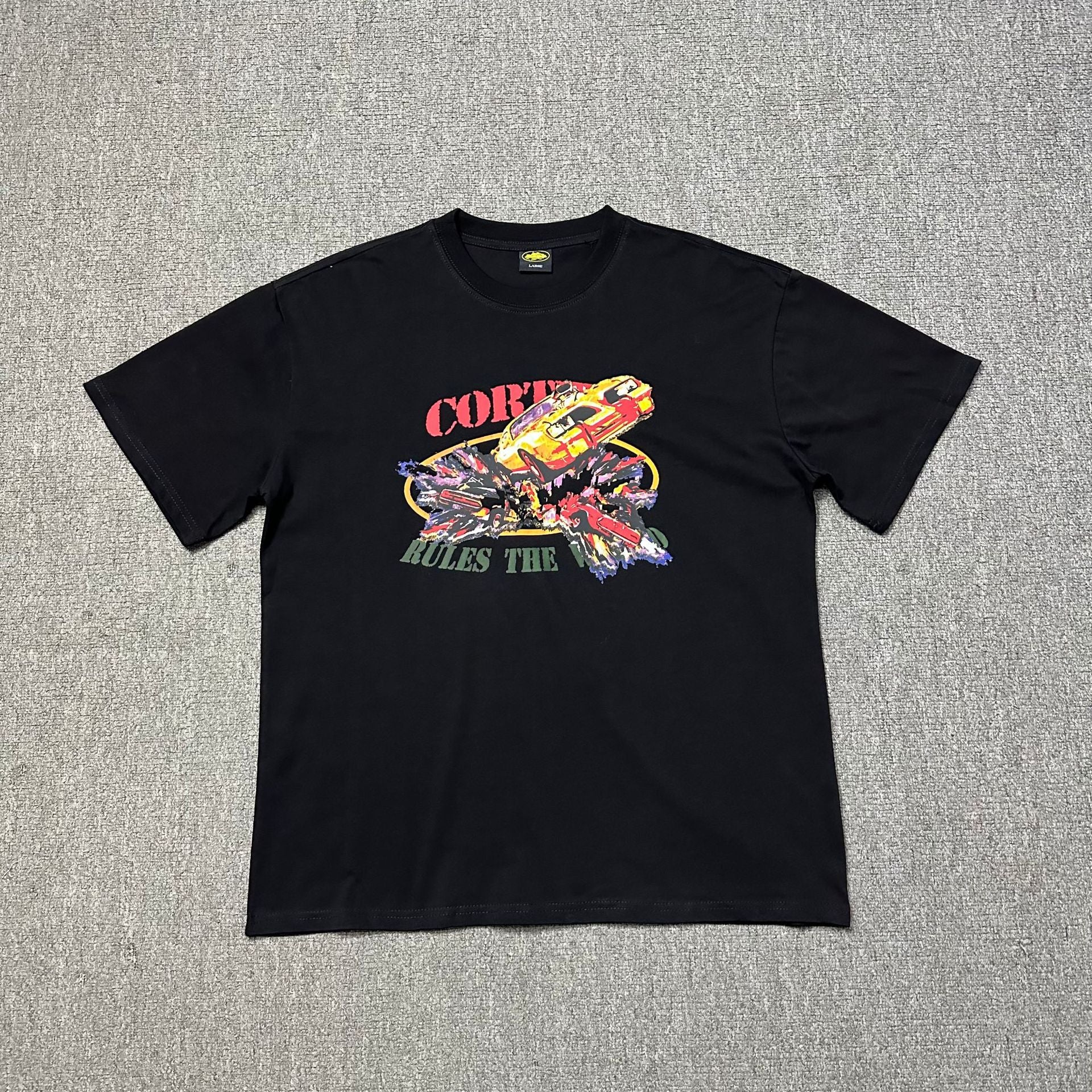 Black t-shirt with colorful graphic design on a gray background
