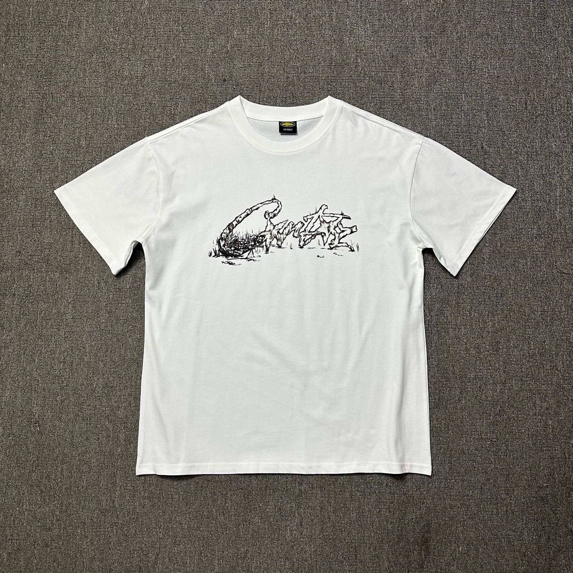 White t-shirt with black graphic design on a gray background