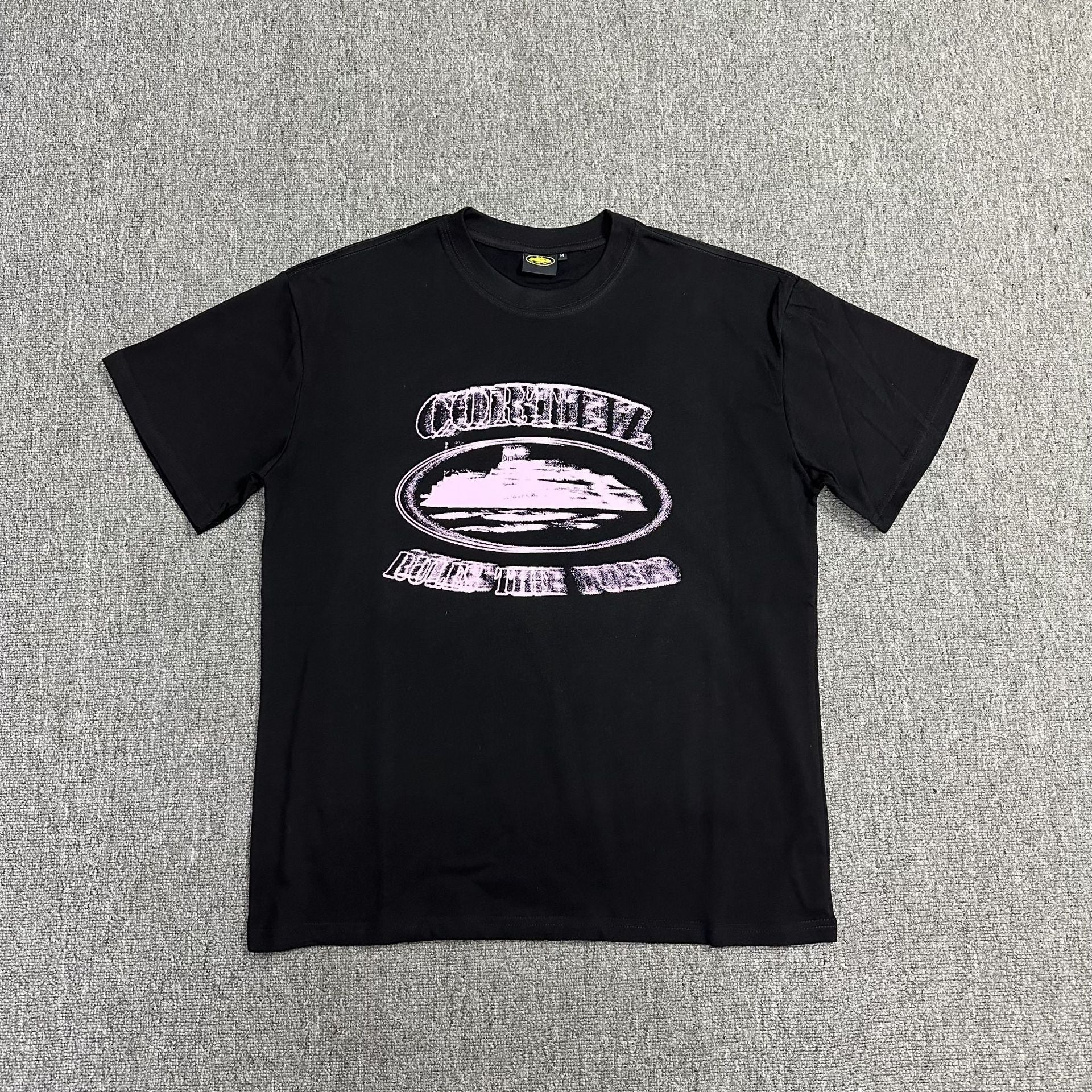 Black t-shirt with a graphic design on a gray background