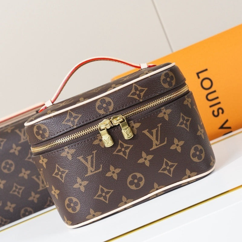 Louis Vuitton monogram canvas cosmetic bag with a top handle, gold-tone hardware, and an orange Louis Vuitton box in the background.