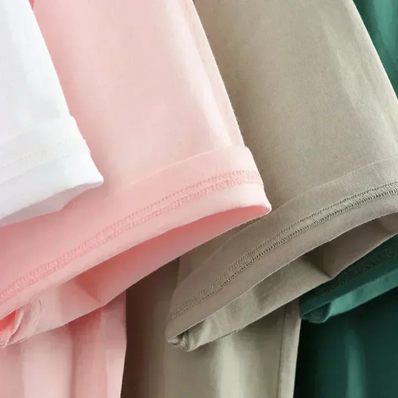 Close-up of pink, beige, and green fabric with visible stitching.