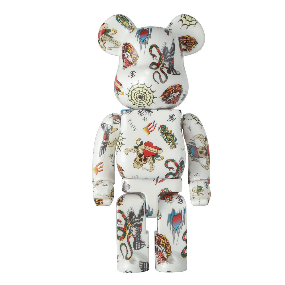 A white Bearbrick toy figure covered in colorful tattoo-style illustrations, shown against a plain white background.