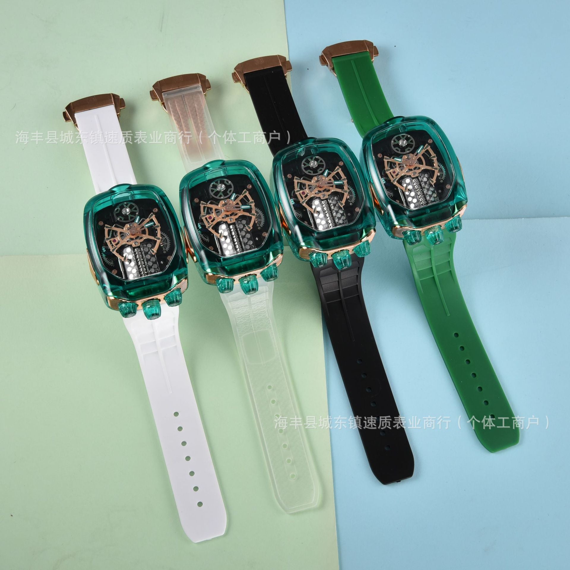 Four watches with green and black straps on a light blue and green gradient background