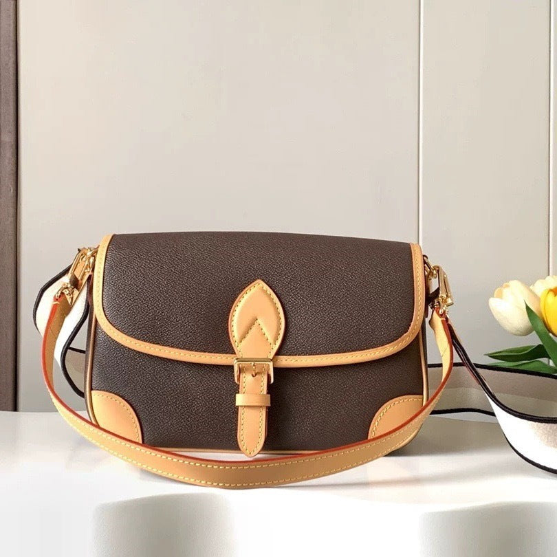 Brown and beige handbag on a white surface with a light gray background